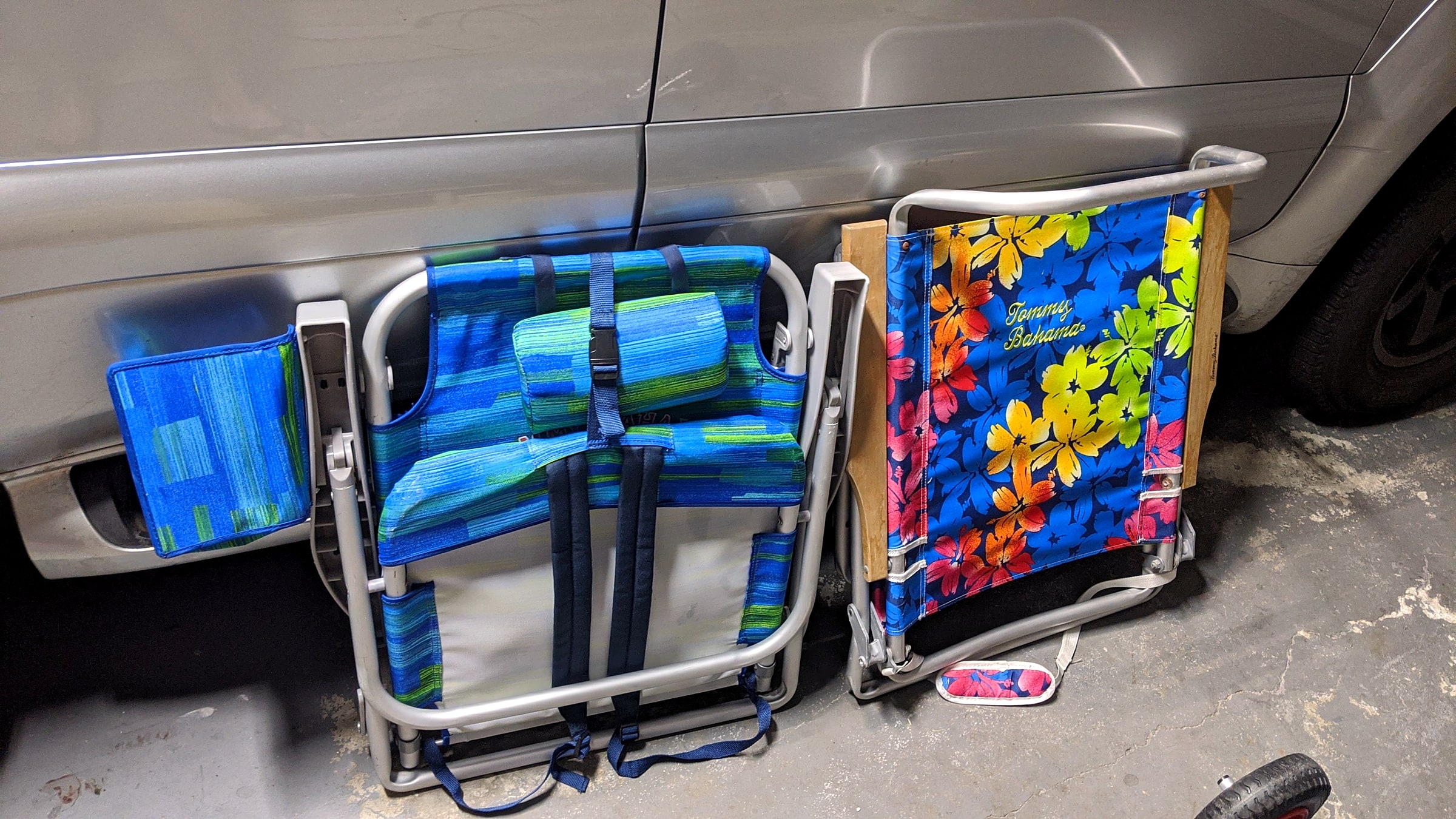 Two Tommy Bahama backpack beach chairs stored in a garage between trips