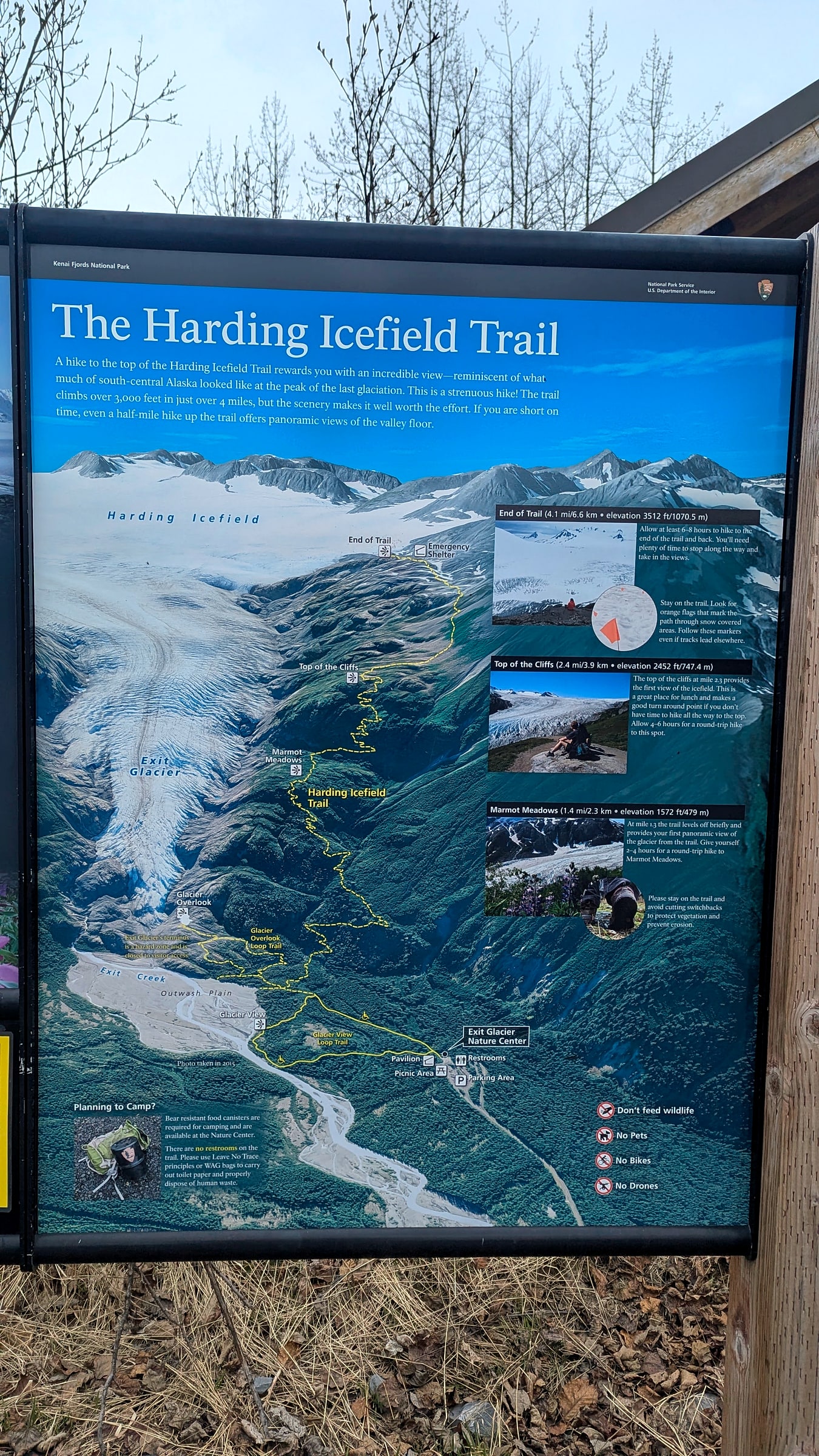 The National Park Service trailhead sign for the Harding Icefield Trail at Kenai Fjords National Park, showing the elevation profile and mileage markers